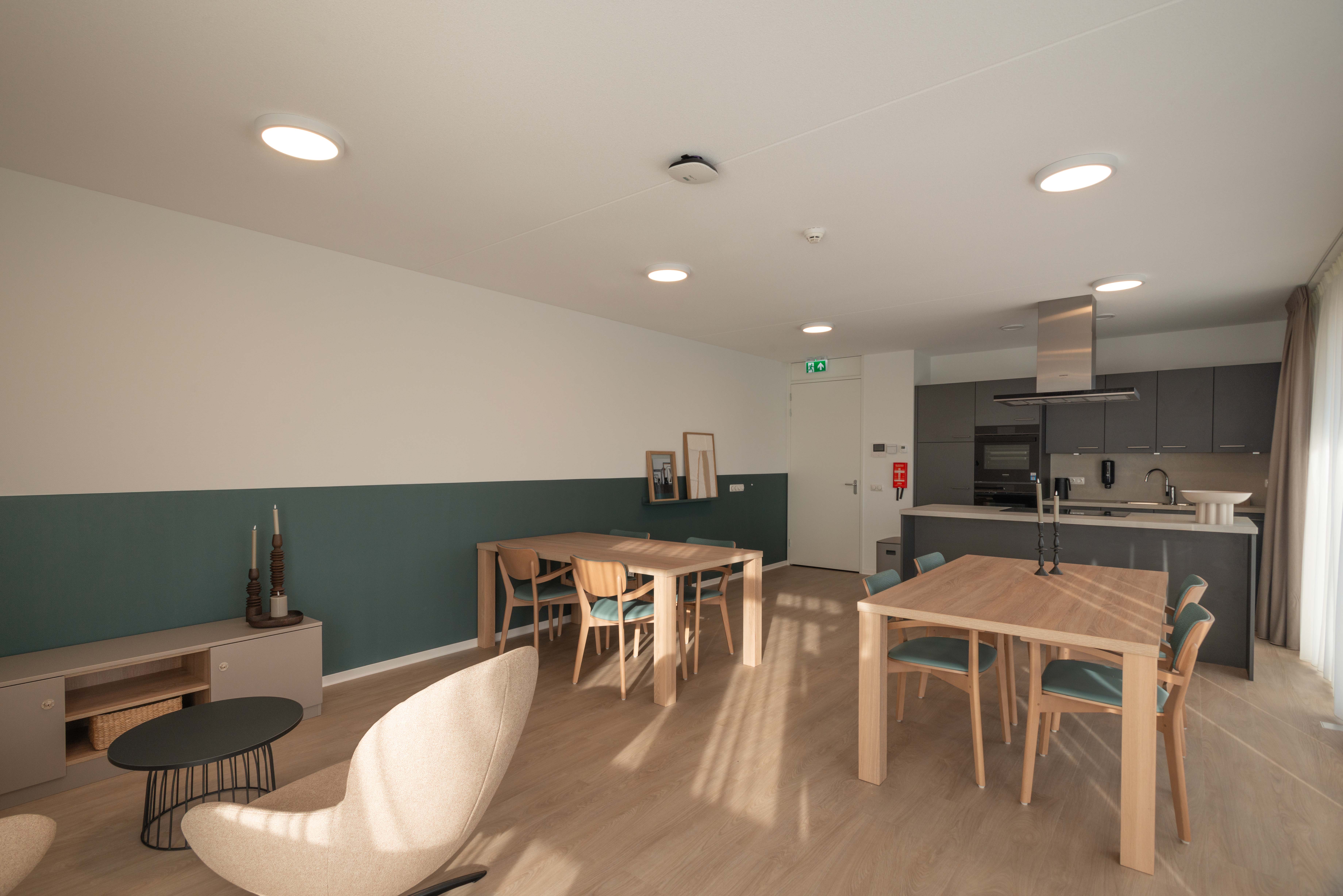 Woonruimte locatie Heuvelstraat Dongen met zitjes, eettafels en keukenblok