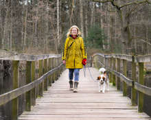 Vrouw wandelt met hond over brug